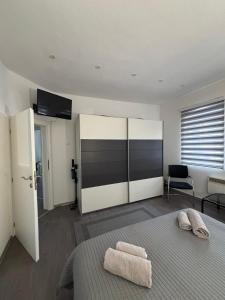 a bedroom with a bed with two towels on it at Apartman DIN in Travnik