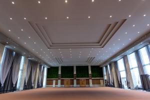 a large room with windows and a ceiling at The Democracy Hotel & Resorts Convention Center in Nashik +87 photos
