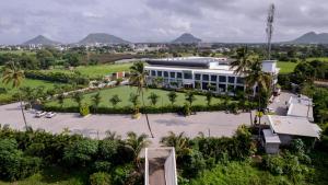 an aerial view of a building with palm trees at The Democracy Hotel & Resorts Convention Center in Nashik