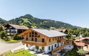 an image of a house with a mountain in the background at Alpenrose in Obermaiselstein