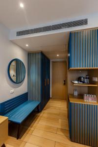 a room with a blue bench and a mirror at The Democracy Hotel & Resorts Convention Center in Nashik