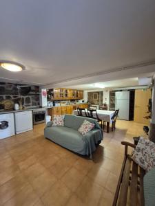 a large living room with a couch and a kitchen at Casa das Pédrinhas Pousade Guarda in Guarda +74 photos