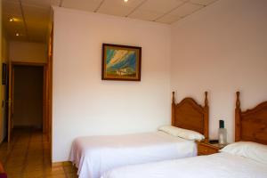 A bed or beds in a room at Hotel Bon Lloc