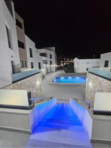a swimming pool at night with blue lights at DD Apartmani in Sutorina