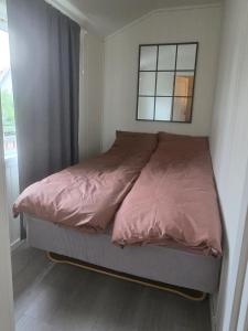 a bed in a small bedroom with a window at Airport Central Apartment in Alta