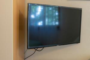a flat screen tv hanging on a wall at Apartments Jurina 2 in Krk