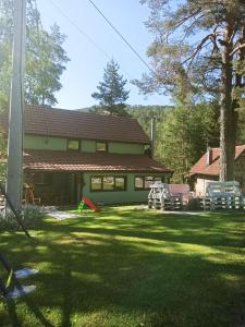 a house with a yard with chairs and a house at Kuća za odmor-Aleksandra in Divčibare
