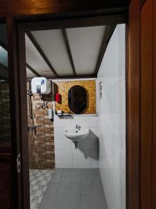 a bathroom with a sink and a mirror at Tetebatu Valley Bungalows in Tetebatu +95 photos