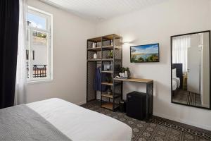 a bedroom with a bed and a mirror at City Port Hotel by Sea N Rent in Haifa