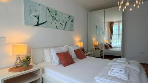 a bedroom with a white bed and a mirror at Бяла Виста Клиф - Byala Vista Cliff in Byala +162 photos