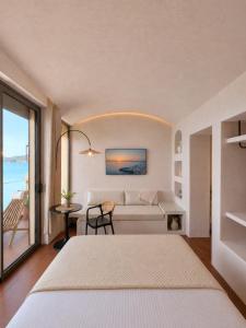 a bedroom with a bed and a view of the ocean at Ca' Mare luxury suite in Mesongi