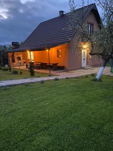 a small house with a lawn in front of it at Файна садиба in Volovets