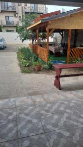 a picnic table and a bench in a courtyard at Vila Mirel in Eforie Nord