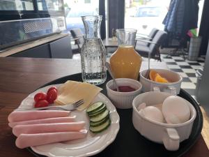 a plate of food with meat and vegetables on a table at Fruenes in Volda