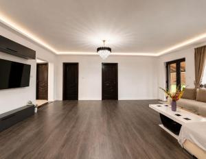 a large living room with a couch and a television at Casa Casy in Oradea