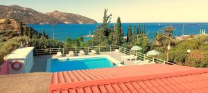 a house with a swimming pool and a view of the ocean at Dimitra Apartments in Agios Nikolaos