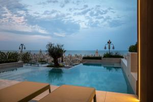 a swimming pool with a view of the city at Hotel Columbia & Ninfea in Lido di Jesolo +71 photos