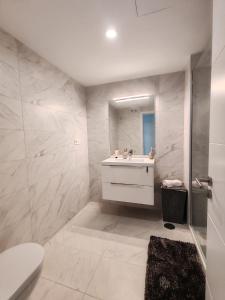 a white bathroom with a sink and a toilet at Vitta Nature Spa - 3 bedrooms in Mijas Costa +17 photos