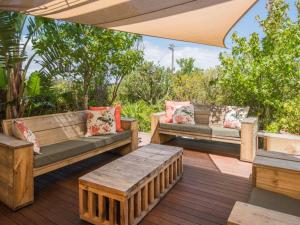 a patio with benches and tables on a deck at 78on5th in Hermanus in Hermanus