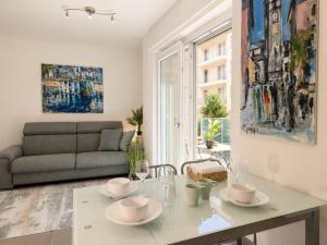 a living room with a table and a couch at Emerald Apartment City Center in Lugano