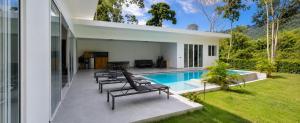 a patio with chairs and a swimming pool at villa Samuel in Koh Samui