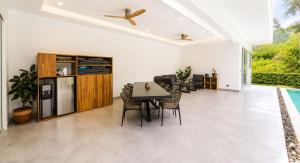 a kitchen and dining room with a table and chairs at villa Samuel in Koh Samui