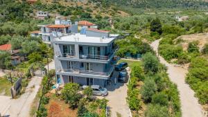 an aerial view of a house with cars parked in front at Vila Andrea in Himare