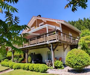 a house with a wrap around porch and a balcony at L'Eden de Floridylle in Xonrupt-Longemer