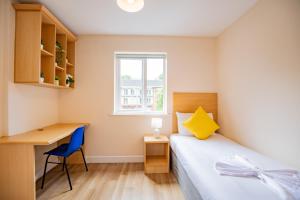 a bedroom with a bed and a desk and a window at Spacious Group Base - 4 Bed Central Limerick in Limerick