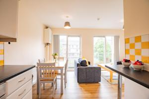a kitchen and living room with a table and chairs at Spacious Group Base - 4 Bed Central Limerick in Limerick +16 photos