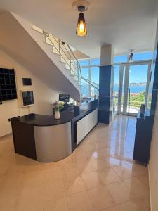 a lobby with a reception desk in a building at AL Hotel in Vlorë
