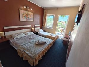 a hotel room with two beds and a window at Shellman Apart Hotel in Odesa +102 photos