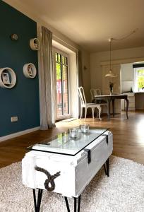 a living room with a table with a glass top at Auszeit in Hasselberg
