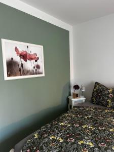 a bedroom with a bed and a picture on the wall at Auszeit in Hasselberg