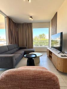a living room with a couch and a flat screen tv at Bliss Getaway Near Protaras in Paralimni