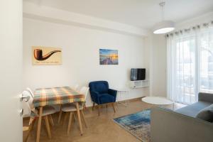 a living room with a couch and a table and chairs at Joni's Condo 10 in Golem