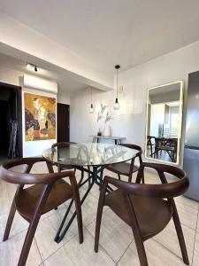 a dining room with a glass table and two chairs at Bliss Getaway Near Protaras in Paralimni