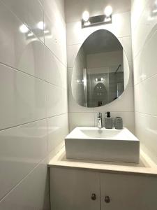 a white bathroom with a sink and a mirror at Bliss Getaway Near Protaras in Paralimni +22 photos