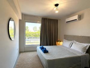 a bedroom with a large bed with a window at Bliss Getaway Near Protaras in Paralimni