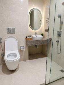a bathroom with a toilet and a sink and a shower at Galaxy Luxury Stay in Ghaziabad +6 photos