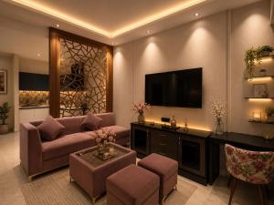 a living room with a couch and a tv at Galaxy Luxury Stay in Ghaziabad