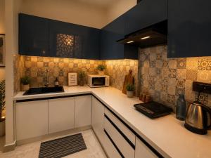 a kitchen with a sink and a microwave at Galaxy Luxury Stay in Ghaziabad