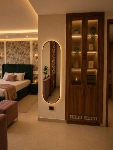a bedroom with a bed and a mirror on the wall at Galaxy Luxury Stay in Ghaziabad