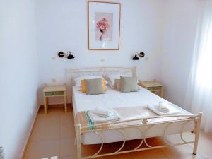 a bedroom with a white bed in a room at Dimitra Apartments in Agios Nikolaos +154 photos
