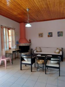 a living room with furniture and a fireplace at IthakiHouse II in Vathi
