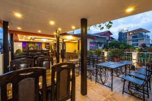 a restaurant with tables and chairs on a patio at Hotel Outfitter Nepal in Kathmandu