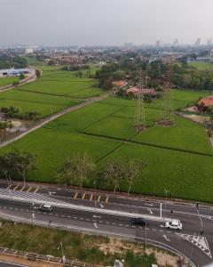 an aerial view of a road and green fields at JayR Homestay Ambience Residence in Malacca