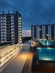 a pool on the roof of a building with buildings at JayR Homestay Ambience Residence in Malacca
