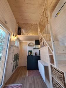 a tiny house with a staircase in the middle at Tiny House L'esquirou in Pourrières