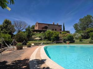 a villa with a swimming pool in front of a house at Città della Pieve Retreat in Città della Pieve